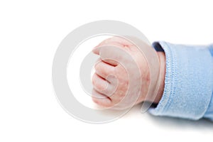 Close up of a child`s fist on white background. Clenched fist - hand of child, baby power. New born baby hand