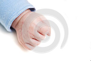 Close up of a child`s fist on white background. Clenched fist - hand of child, baby power. New born baby hand