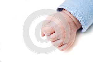 Close up of a child`s fist on white background. Clenched fist - hand of child, baby power. New born baby hand