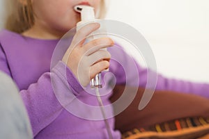 Close-up of a child& x27;s hand with a nebulizer