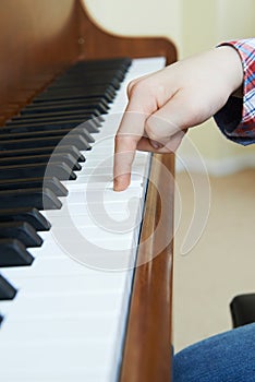 Close Up Of Child`s Hands Playing Piano