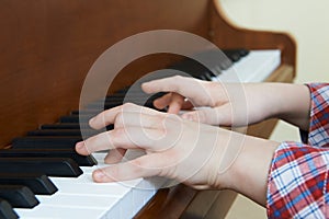 Close Up Of Child's Hands Playing Piano