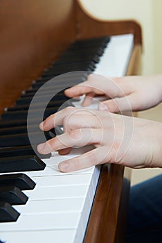 Close Up Of Child`s Hands Playing Piano