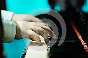 Close-up of a child's hands playing piano with precision