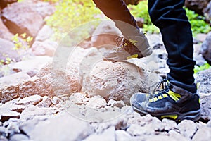 Close up on child trekking shoes on mountains trail