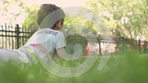 Close up Child using Digital Tablet sitting on the grass outdoors