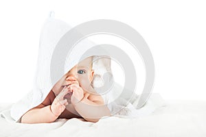 Close-up child in white towel isolated on white background. Bathing babies and restful sleep. funny toddler. photo
