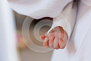 Close-Up of a Child& x27;s Hand Grasping in Soft Fabric photo