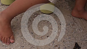 A close-up of children feet walking on the sand in the playground.