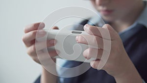 Close-up of children`s hands and mobile phone.