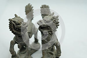 Close-up of Chinese bronze Qilin figurines, mythical creatures with dragon head, deer antlers, fish scales, ox hooves & lion tail