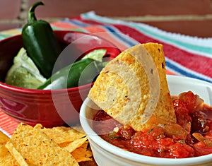 Close-up of Chips and Salsa and chile peppers photo