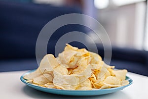 Close up of chips snack sitting on coffe table.