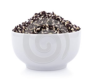 Chocolate chip morsels spread in bowl on white
