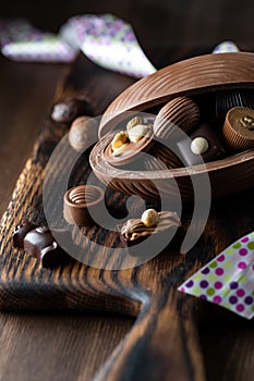 Close up of a chocolate Easter egg filled with various gourmet chocolates. An Easter concept.