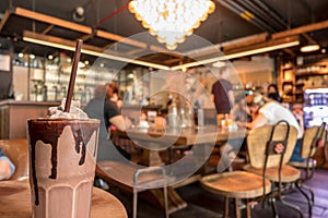 Chocolate frappe with blurred cafe background photo