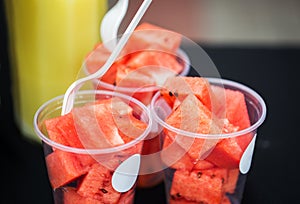 Close up of chopped watermelon in plastic cups