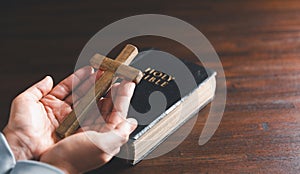 Close up Christian woman hands holding a cross holy and worship. Spirituality and religion Concept, Person holding christian cross