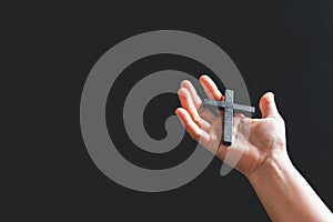 Close up Christian woman hands holding a cross holy and worship. Spirituality and religion Concept, Person holding christian cross