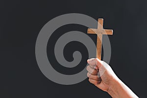 Close up Christian woman hands holding a cross holy and worship. Spirituality and religion Concept, Person holding christian cross