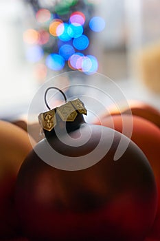 Close-up of christmas balls in front of blurred christmas lights