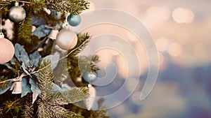 Close-up of Christmas tree decorated with Christmas bauble and bokeh background, vintage tone horizontal view.