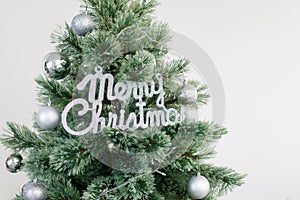 Close up Christmas tree decorated with silver ornament. Photo with copy space