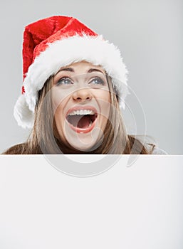 Close up christmas woman portrait behind big white card. Emotio
