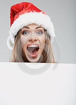 Close up christmas woman portrait behind big white card. Emotio