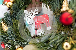 Close Up of a Christmas Wreath With Reindeer Ornament