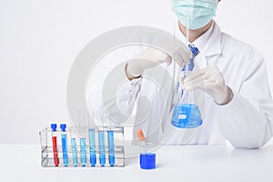 Close up of cientist is testing and researching some blue liquid chemical in laboratory isolated white background