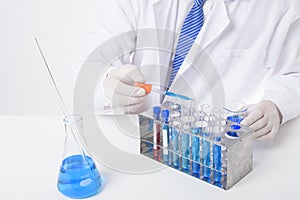 Close up of cientist is testing and researching some blue liquid chemical in laboratory isolated white background