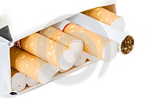Close-up of cigarettes in pack isolated on white background.