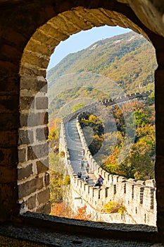 CLOSE UP: Cinematic view of tourists exploring the historic Great Wall of China.
