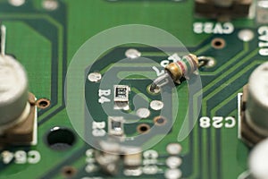 Close-up circuit board with electronic components on green printed
