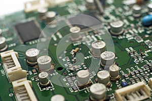 Close-up circuit board with electronic components on green printed