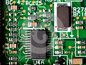 Close-up of circuit board with integrated circuits, resistors and capacitors