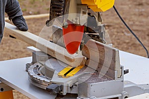 Close up of Circular saw cutting sharp rotary blade new wood board woodwork