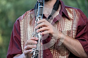 Close up of clarinet player playing at a Klezmer concert of Jewish fusion music in Regent`s Park in London