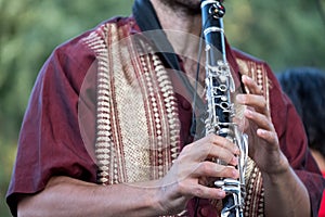 Close up of clarinet player playing at a Klezmer concert of Jewish fusion music in Regent`s Park in London