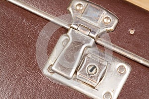 Close up of a clasp of an old fashioned suitcase