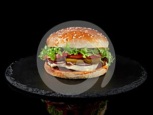 Close-up of a classic burger with meat and vegetables and sauce