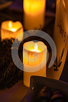 Close up of classic candle with orange flames burning on