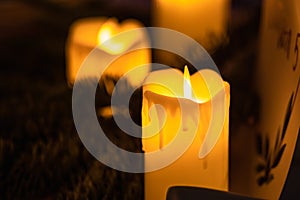 Close up of classic candle with orange flames burning on