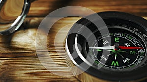 Close-Up of a Classic Compass Beside a Rope on a Wooden Surface During Daylight