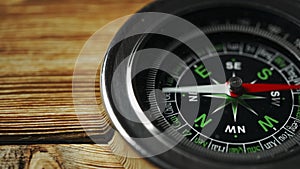 Close-Up of a Classic Compass Beside a Rope on a Wooden Surface During Daylight