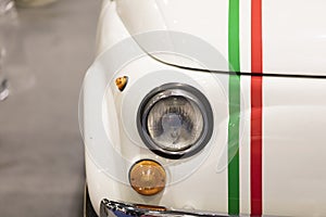 A close up of a classic vintage car headlight