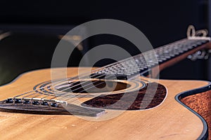 Close-up of a classical acoustic guitar on a black background