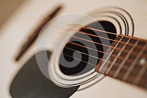 Close up of classical acoustic guitar strings and neck with frets