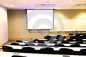 Close up on classroom, seat, table and projector screen